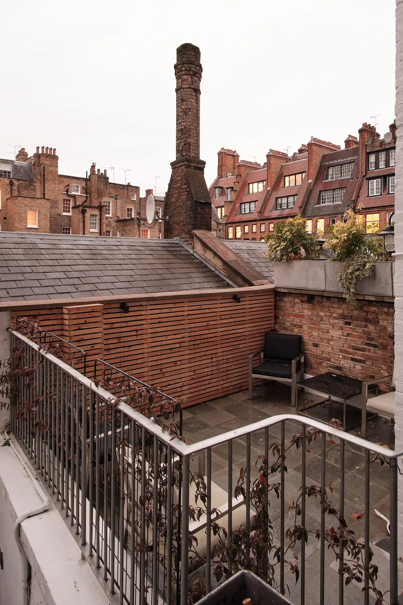Chelsea II: roof terrace looking out across red-brick mansion roofs and chimney stacks