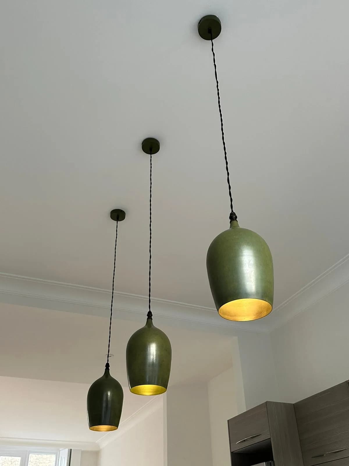 Chelsea II: three olive-green ceramic pendants hung above the kitchen worktop