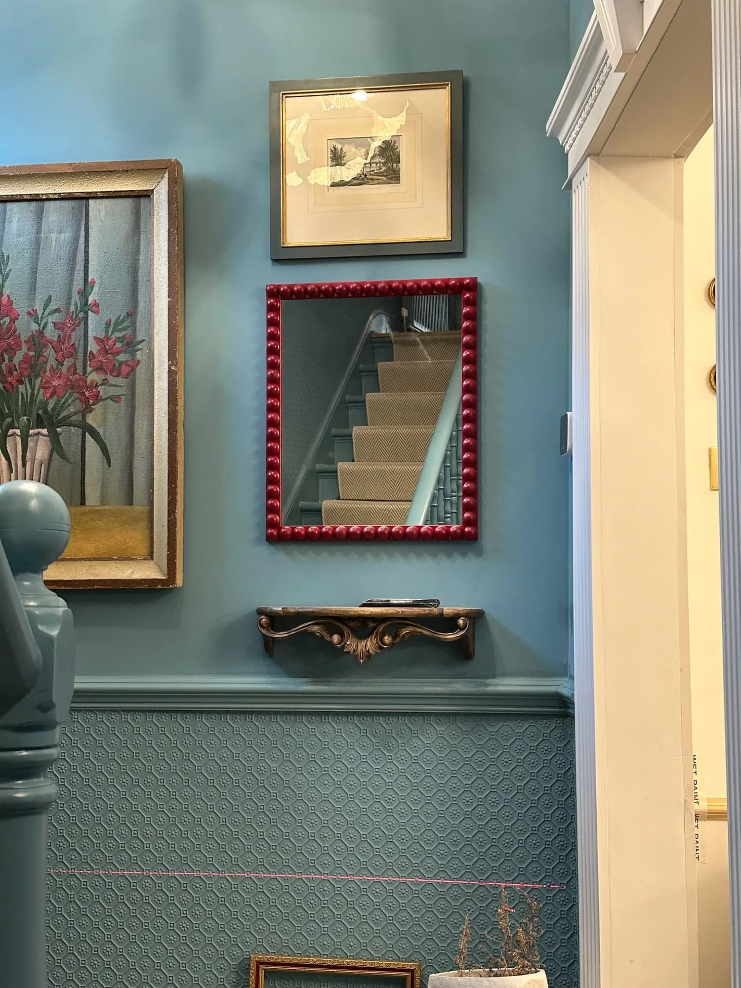 Earls Court I: blue stair hall with an embossed dado and gilt-framed pictures