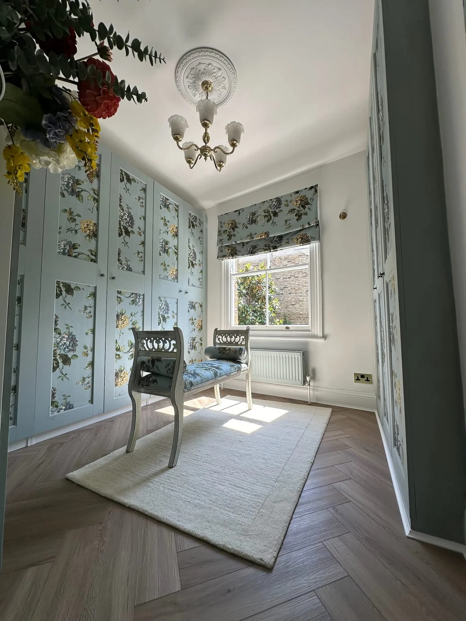 Earls Court III: bedroom with floral wallpaper, fitted wardrobes and a herringbone floor