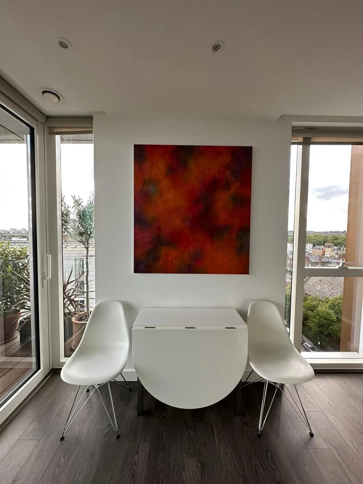 Finsbury Park: dining table between full-height windows opening to a balcony