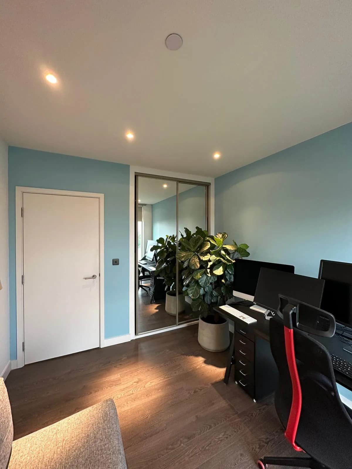 Finsbury Park: study with mirrored wardrobes and a desk under recessed lights