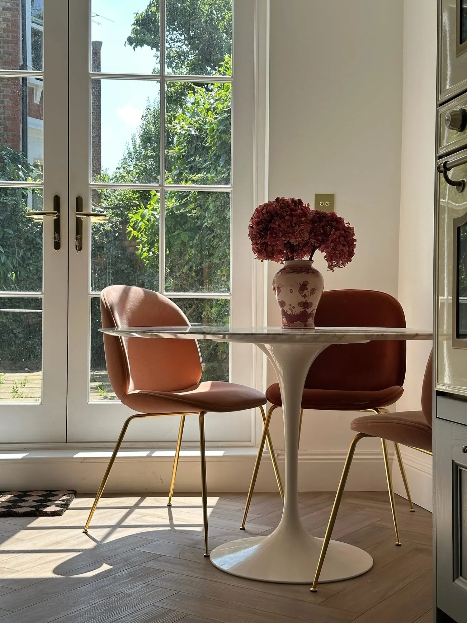 Earls Court II: breakfast table for two in front of tall garden doors