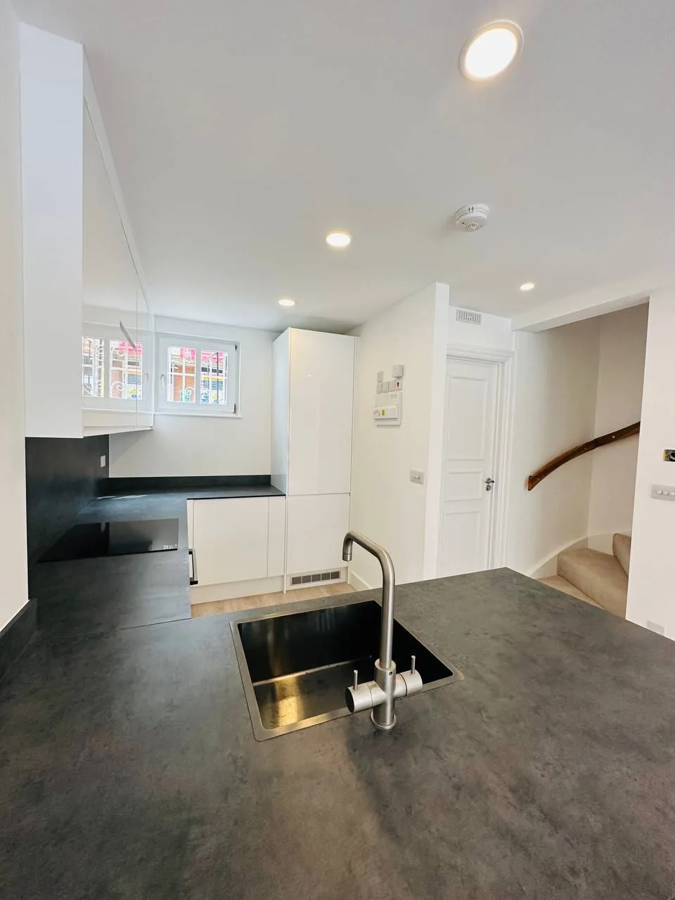 High Street Kensington: kitchen with dark stone worktops and an undermount sink